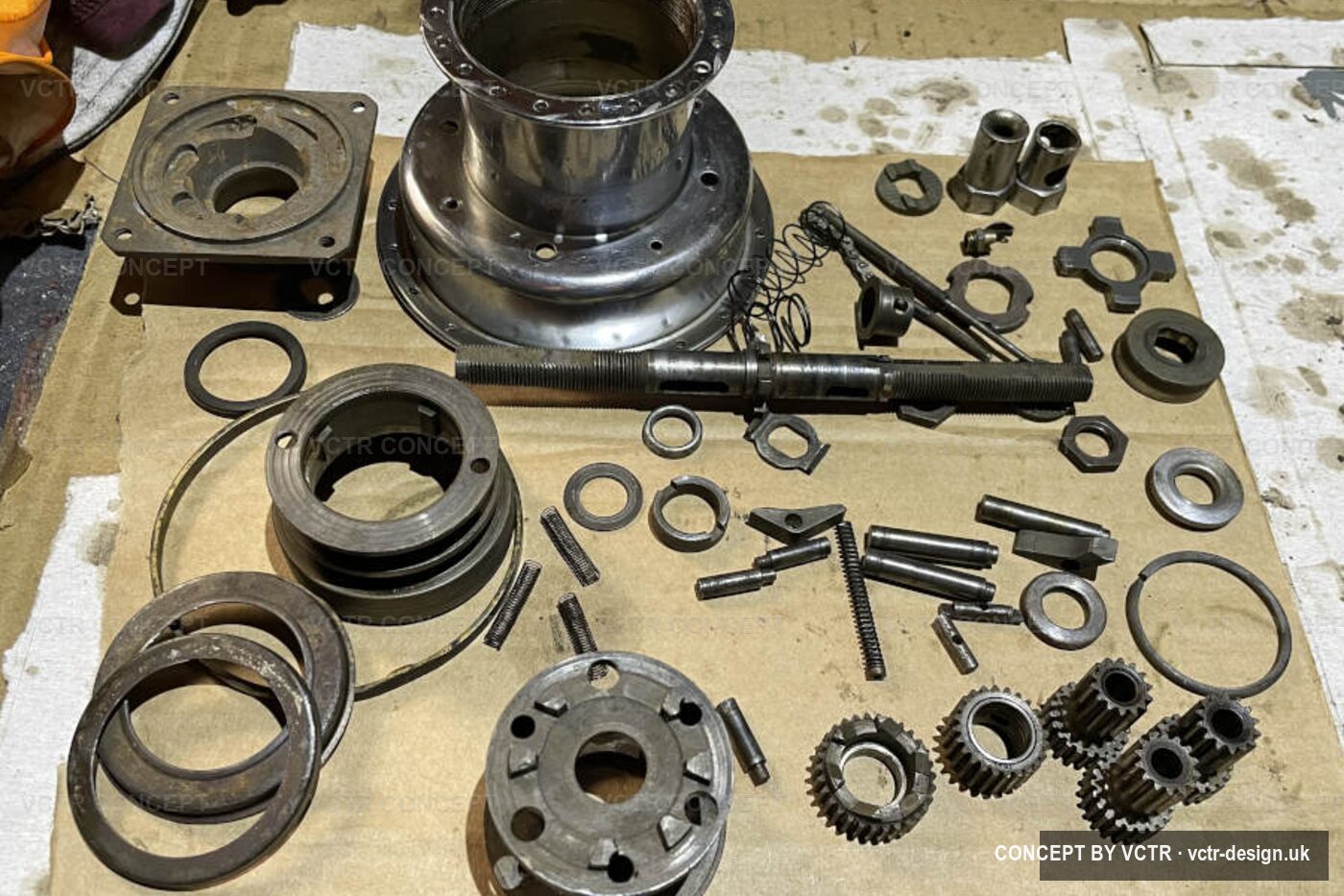 A Sturmey-Archer hub stripped into its parts on the bench