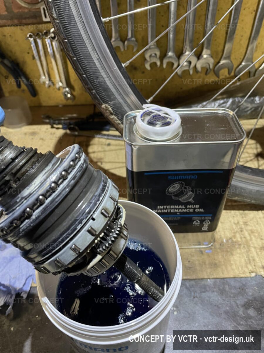A Shimano hub being serviced in an oil bath