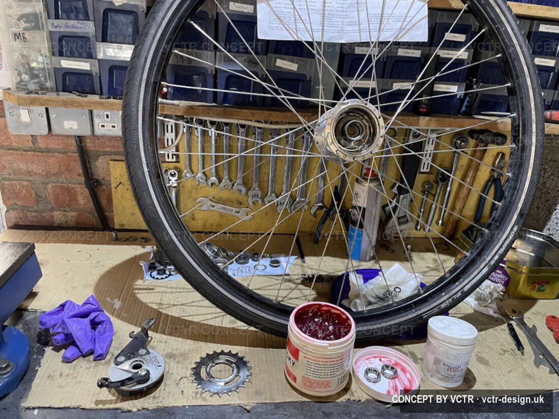 A wheel and hub on the workbench with tools